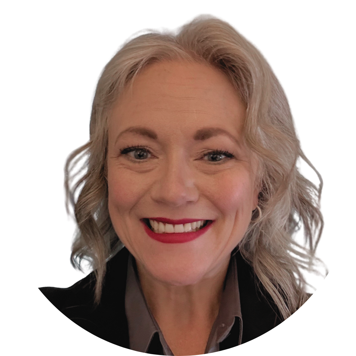 Smiling white woman with lightly curled grey hair, wearing a dark grey collared shirt and black blazer.